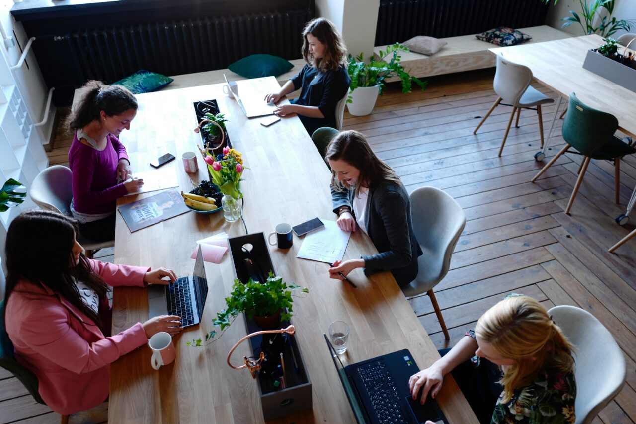 Female entrepreneurs working at a table with laptops