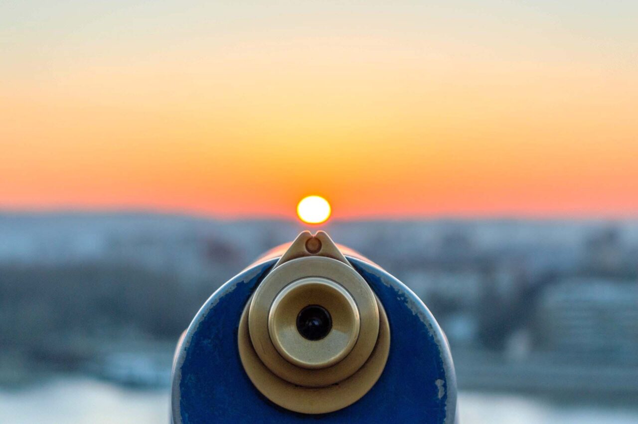 Telescope overlooking the ocean and sunset
