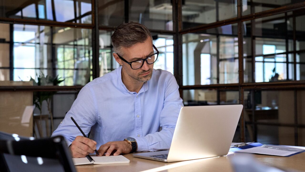 Man working on laptop looking at an alternative asset platform